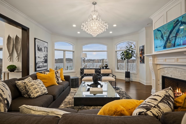 living area with dark wood finished floors, a brick fireplace, crown molding, and baseboards