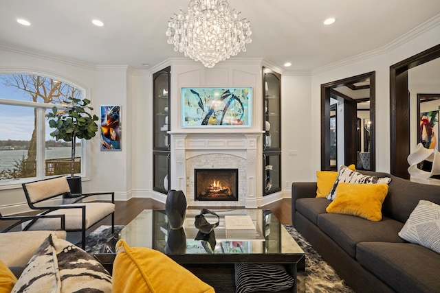 living area featuring a lit fireplace, ornamental molding, dark wood finished floors, and recessed lighting