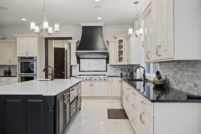 kitchen featuring crown molding, custom range hood, an inviting chandelier, appliances with stainless steel finishes, and a sink