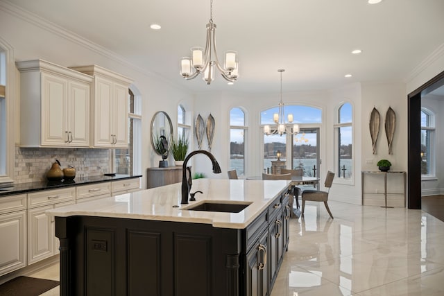 kitchen with crown molding, tasteful backsplash, hanging light fixtures, an inviting chandelier, and a sink