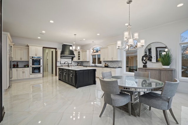 dining space with a chandelier, marble finish floor, and crown molding