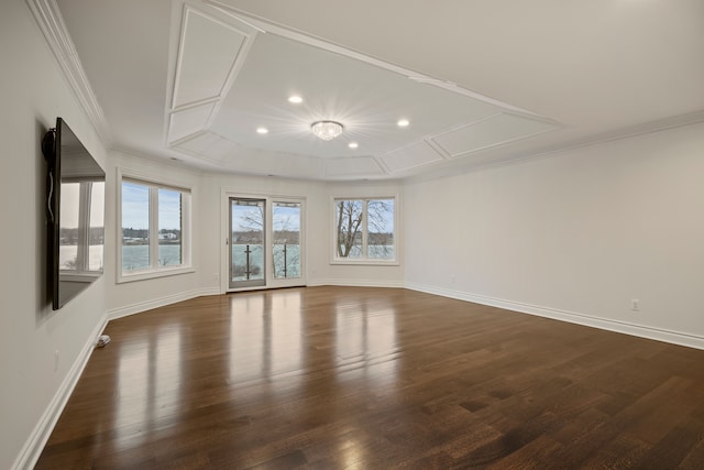 unfurnished room featuring recessed lighting, a raised ceiling, ornamental molding, wood finished floors, and baseboards