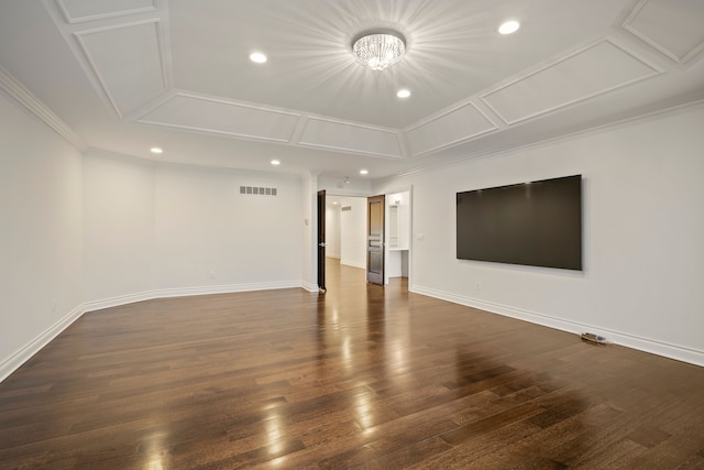 empty room with ornamental molding, visible vents, dark wood finished floors, and baseboards