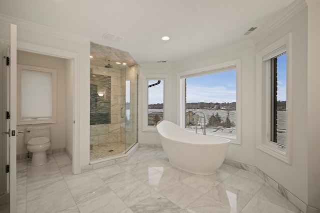 bathroom featuring marble finish floor, ornamental molding, a shower stall, and visible vents