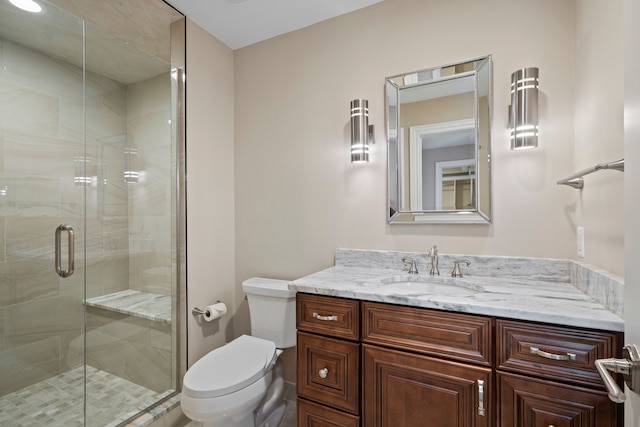 full bath with a shower stall, toilet, and vanity