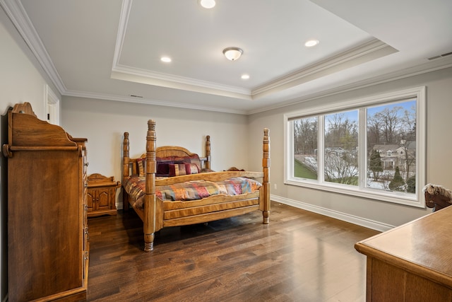 bedroom with visible vents, a raised ceiling, and dark wood finished floors