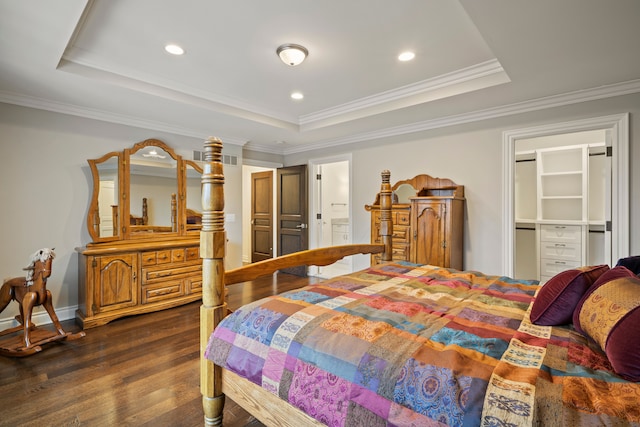 bedroom with crown molding, a raised ceiling, and dark wood finished floors