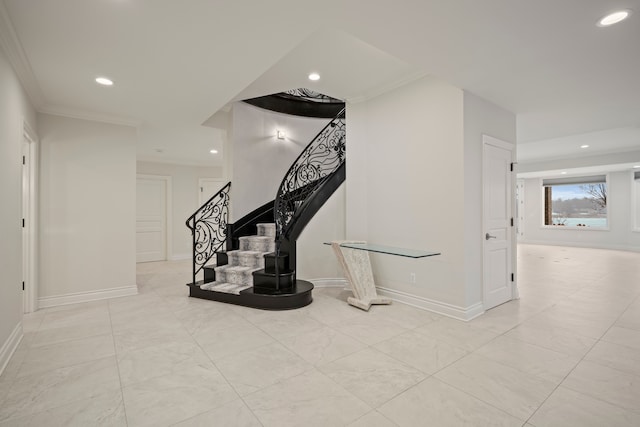 staircase featuring baseboards, ornamental molding, and recessed lighting