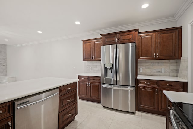 kitchen with ornamental molding, light countertops, appliances with stainless steel finishes, and backsplash