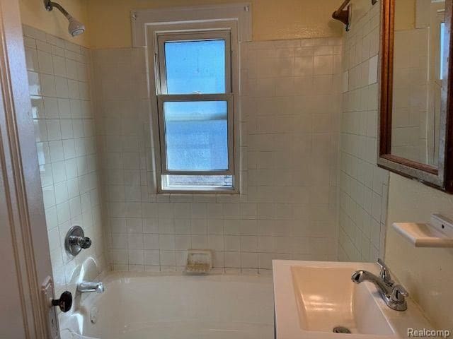 bathroom featuring shower / tub combination and a sink