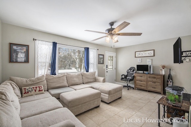 living room with a ceiling fan, baseboards, and light tile patterned floors