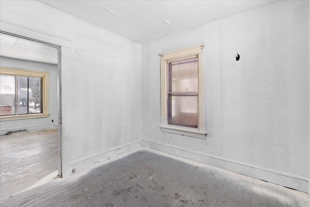 unfurnished room featuring visible vents and wood finished floors