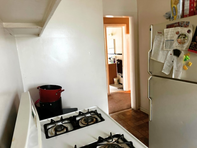 kitchen featuring freestanding refrigerator and stovetop