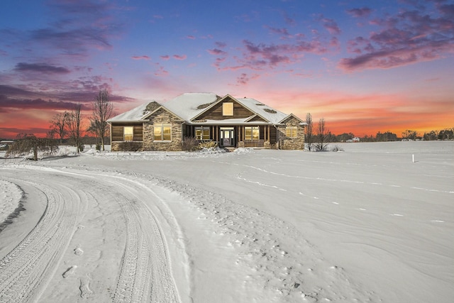 view of front of property featuring stone siding and covered porch