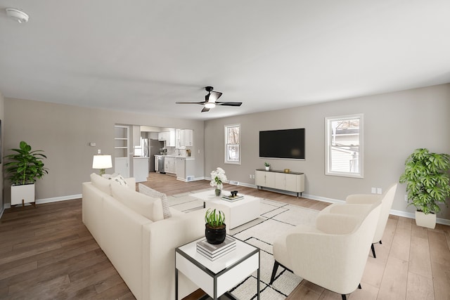 living area featuring wood finished floors, a wealth of natural light, and baseboards