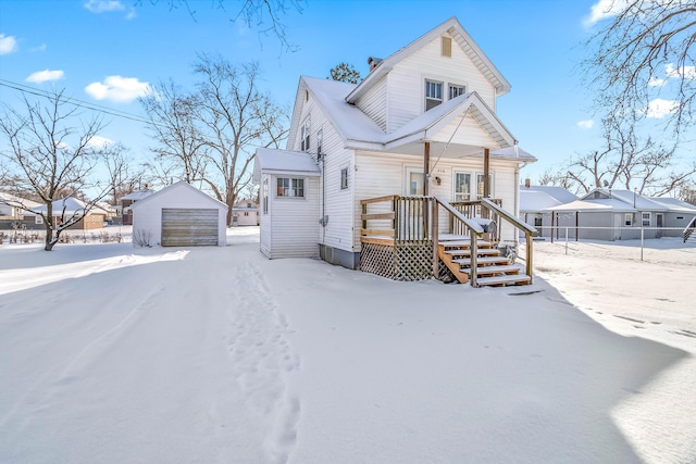 view of front of property with a detached garage and an outdoor structure