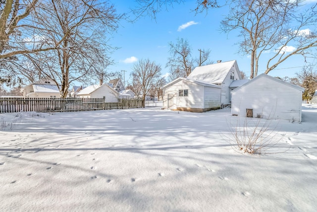 yard covered in snow featuring fence and a residential view