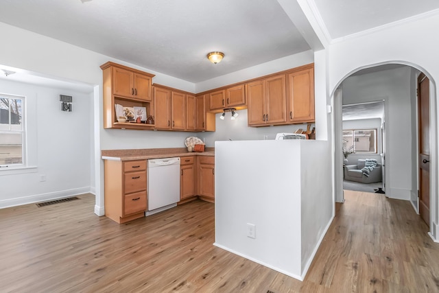 kitchen with arched walkways, light countertops, light wood-type flooring, dishwasher, and open shelves