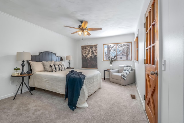 bedroom featuring light carpet, baseboards, visible vents, and ornamental molding