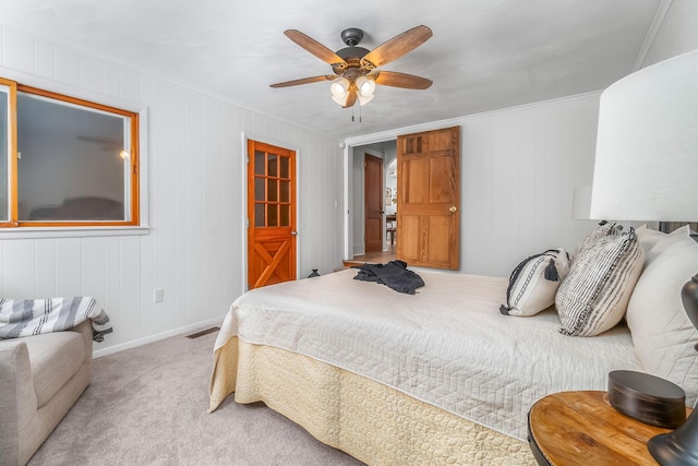 carpeted bedroom with ornamental molding, a ceiling fan, and baseboards