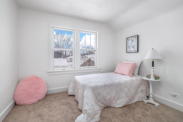 bedroom featuring lofted ceiling, baseboards, and light colored carpet