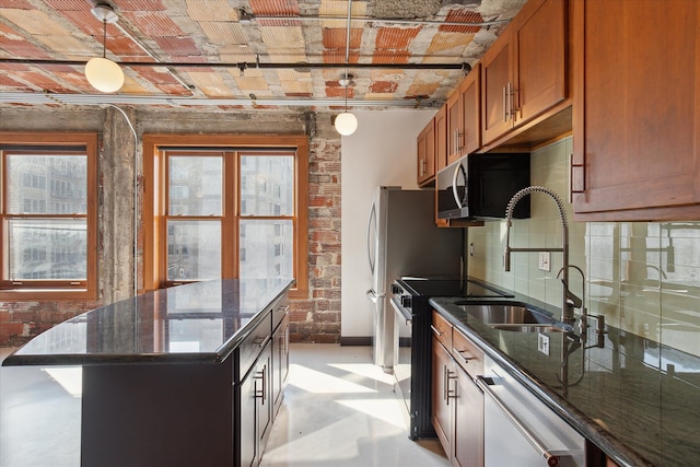 78 Watson St Unit 13, Detroit, MI 48201 - kitchen featuring dark stone counters, brick wall, brown cabinetry, a center island, and dishwasher