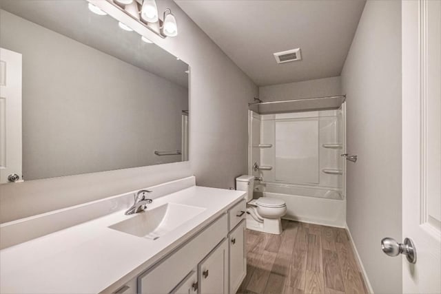 full bathroom with visible vents, toilet, vanity, shower / tub combination, and wood finished floors