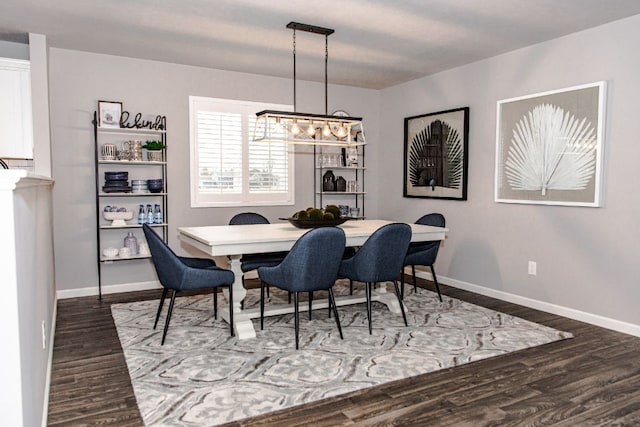 dining space featuring baseboards and dark wood-style flooring