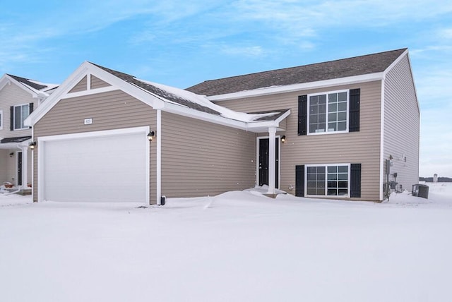 view of front of house featuring a garage and central air condition unit