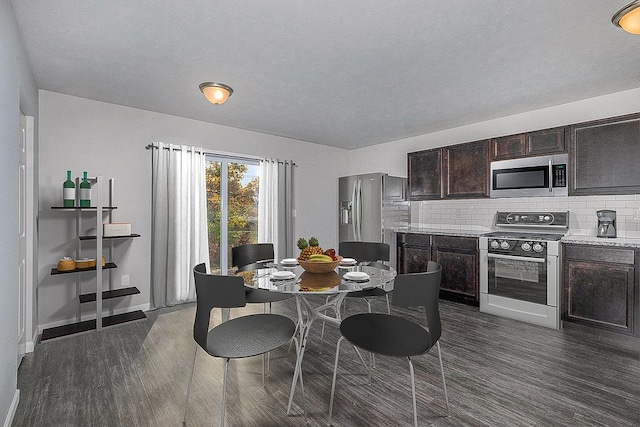 dining area with dark wood finished floors, a textured ceiling, and baseboards