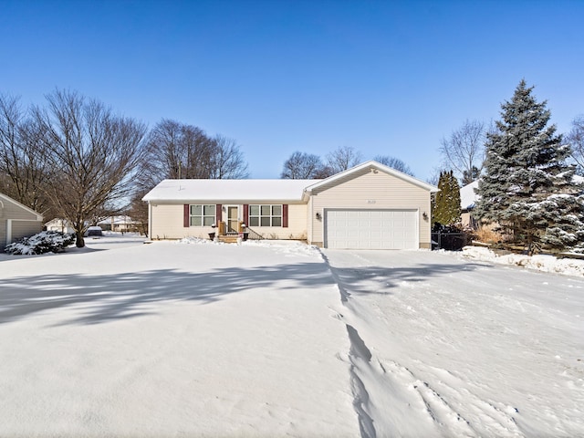 single story home with driveway and an attached garage