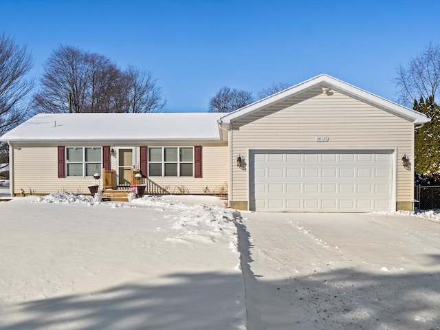 ranch-style house with a garage and driveway