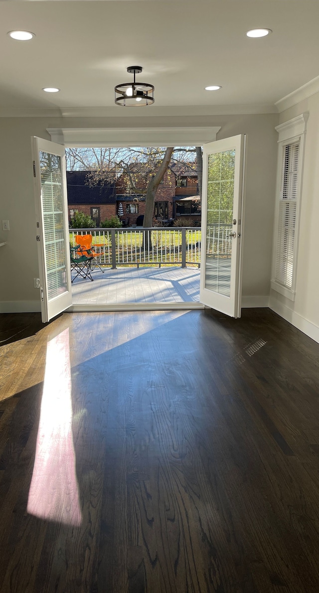 doorway with recessed lighting, wood finished floors, and baseboards