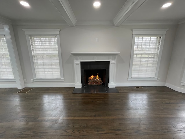 unfurnished living room featuring a lit fireplace, a wealth of natural light, dark wood-style flooring, and beam ceiling