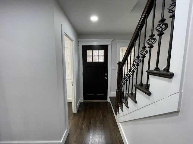 foyer featuring dark wood-style floors, recessed lighting, baseboards, and stairs