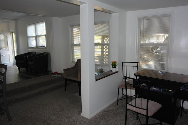 carpeted dining room with baseboards