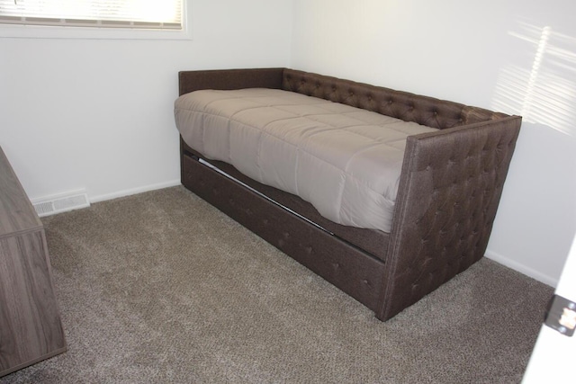 carpeted bedroom featuring baseboards and visible vents