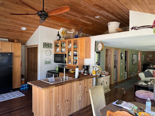 kitchen with glass insert cabinets, dark wood finished floors, lofted ceiling, a peninsula, and black appliances