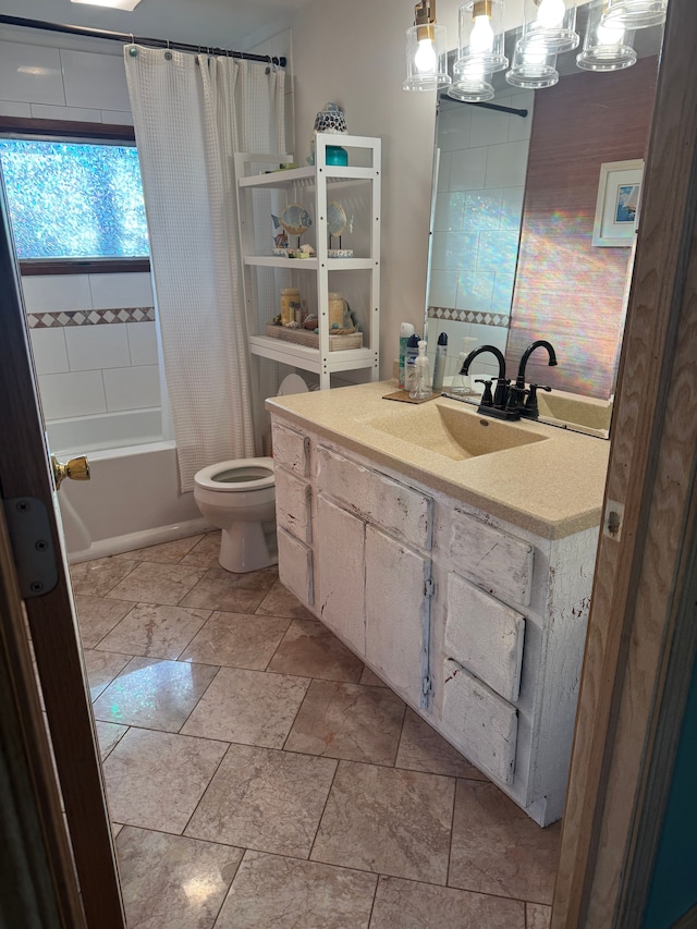 bathroom with vanity, shower / bath combination with curtain, and toilet