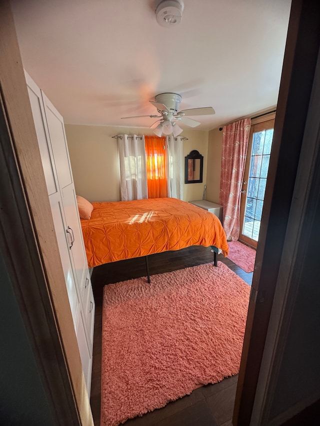 bedroom featuring ceiling fan and access to outside