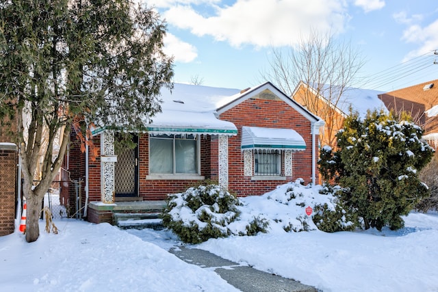 bungalow-style home featuring brick siding