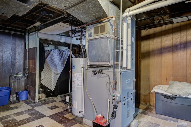 utilities with water heater and visible vents