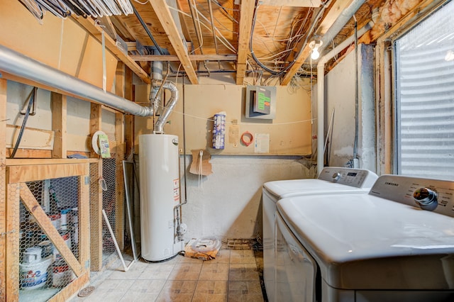 washroom featuring laundry area, water heater, and independent washer and dryer