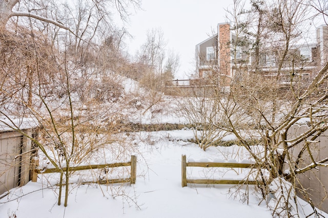 snowy yard with fence