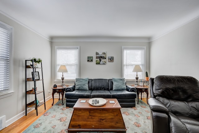 living room with plenty of natural light, crown molding, and wood finished floors