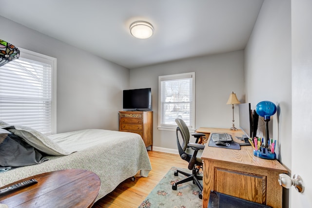 bedroom featuring light wood-style flooring and baseboards