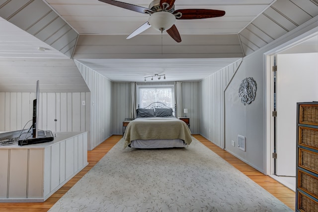 bedroom featuring a ceiling fan, visible vents, and light wood finished floors