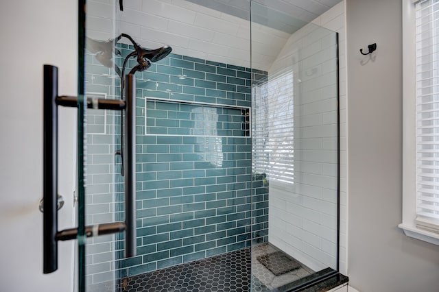 full bathroom with a stall shower and lofted ceiling