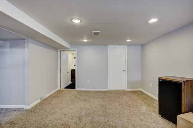 finished basement featuring recessed lighting, baseboards, visible vents, and light colored carpet