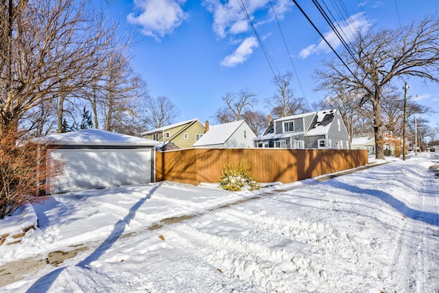 exterior space with a detached garage, a residential view, and an outdoor structure